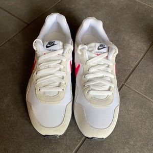 Nike white sneakers with pink swoosh